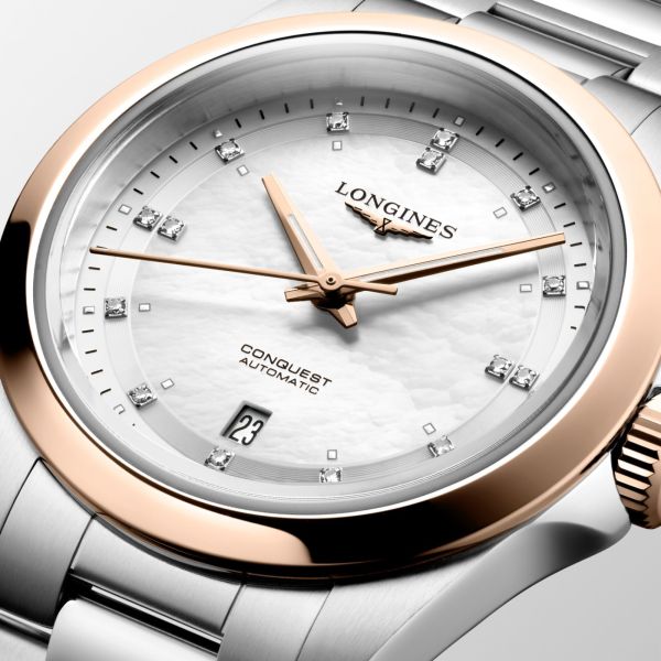 Montre Longines Conquest automatique cadran nacre blanche lunette or rose bracelet acier et or rose 30 mm