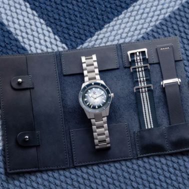 Rado Captain Cook automatic watch with blue dial, stainless steel bracelet, blue leather strap, and blue and white fabric strap,